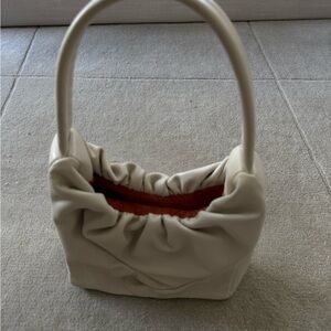 STAUD Felix ruched leather top handle bag.